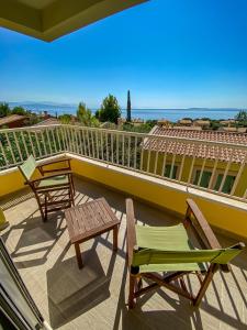 two chairs and a table on a balcony with a view at La Riviera Barbati Seaside Apartments & villas in Barbati