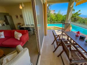 a living room with a red couch and a table at La Riviera Barbati Seaside Apartments & villas in Barbati
