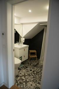 a bathroom with a sink and a toilet in a room at Casa do Arco in Amarante +33 photos