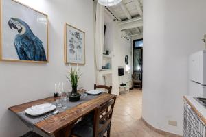 a dining room with a table and a bird on the wall at Nostromondo Apartments Rome City Centre in Rome