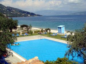 a swimming pool with a view of the ocean at La Riviera Barbati Seaside Apartments & villas in Barbati