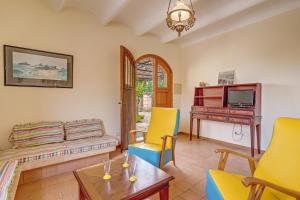 a living room with a couch and a piano at Possessio Sa Barrala Casa del Pages in Campos