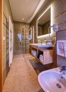 a bathroom with a sink and a shower at Garni Appartments Helvetia in Villabassa