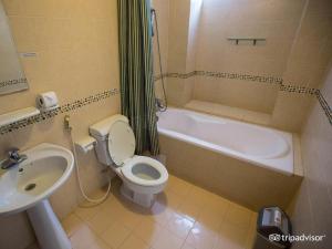 a bathroom with a sink and a toilet and a bath tub at Khách sạn Minh Châu - Hòa Hưng in Ho Chi Minh City