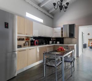 a kitchen with a table with a bowl of fruit on it at Sinanis city home in Volos