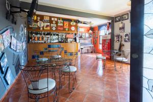 a restaurant with tables and chairs and a bar at Hotel Ángel Inn in Oaxaca City