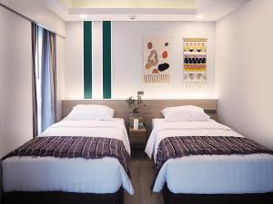 Postel nebo postele na pokoji v ubytování Darley Hotel Chiangmai