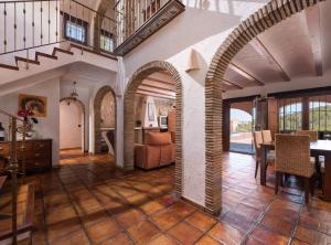 a living room with an archway and a dining room at Villa Vinyent - Plusholidays in Calpe