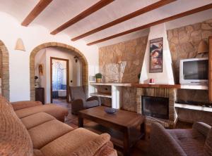 a living room with a couch and a fireplace at Villa Vinyent - Plusholidays in Calpe