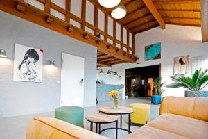 a living room with a couch and a table and chairs at Hotel Restaurant Fronmühle in Bad Dürkheim