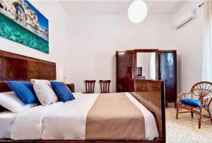 a bedroom with a large bed with blue pillows at La Casa di Julia in Lecce +39 photos