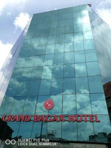 a building with a sign on the side of it at Grand Bagan Hotel in Butterworth