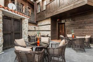 a patio with a table and chairs and a building at Effect Boutique Villa Azzura - Adults Only in Nesebar