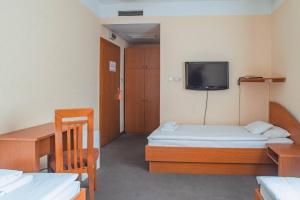 Un pat sau paturi într-o cameră la Homoky Hotels Bestline Hotel