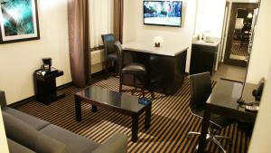 a living room with a couch and a table at Holiday Inn Express Hollywood Walk of Fame by IHG in Los Angeles