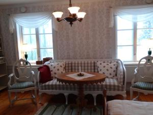 - un salon avec un canapé, deux chaises et une table dans l'établissement Röda stugan, à Hedemora
