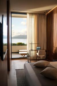 a hotel room with a bed and a large window at Hotel Dubrovnik Palace in Dubrovnik