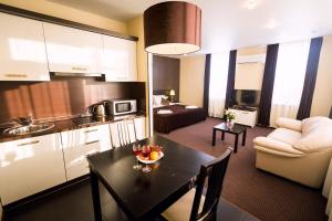 a kitchen and a living room with a table in a room at History Hotel in Vologda