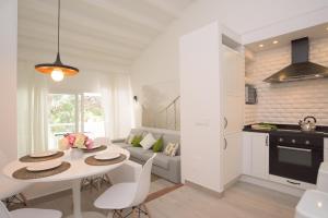 a kitchen and a living room with a table and chairs at Apartamento Ferrera Park 624 in Felanitx