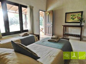 Postel nebo postele na pokoji v ubytování Arandu ecolodge