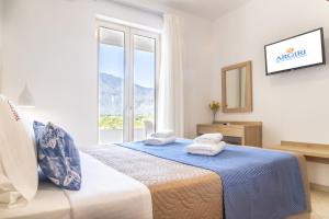 a bedroom with a bed with towels on it at Argiri Apartments & Suites in Georgioupolis