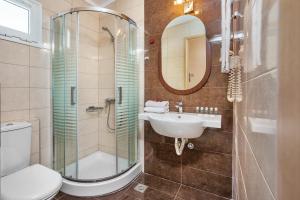 a bathroom with a toilet and a sink and a shower at Iris Hotel in Siviri