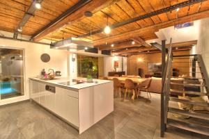a kitchen and dining room with a dining table at Maison avec piscine et jardin- 4 chambres 8 pers in Cuers