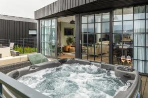 a hot tub in the middle of a living room at Retallack Resort by Away Resorts in Padstow