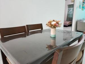 a table with a vase of flowers on top of it at Lake Residence No165 @aesthetic lake view & best photograph in Puchong