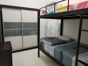 a room with two bunk beds and a desk at Lake Residence No165 @aesthetic lake view & best photograph in Puchong