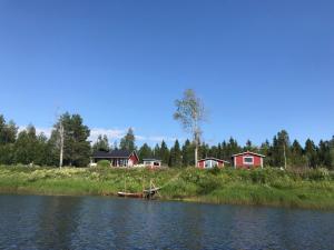 a body of water with houses in the background at Villa Saagala by Tornio River in Tornio