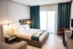 Posteľ alebo postele v izbe v ubytovaní Lagaria Hotel