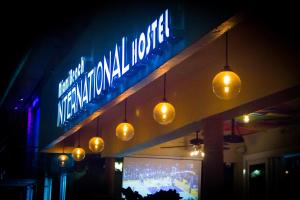 a sign for a restaurant with lights hanging from it at Miami International by Lowkl in Miami Beach