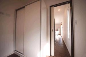 a hallway with a large sliding glass door at Tiny House Necochea in Necochea