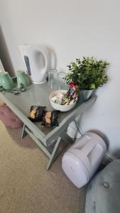 a table with a plant and a bowl on it at The Albert Hotel in Shrewsbury