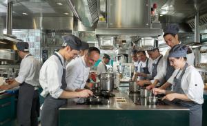 a group of men in a kitchen preparing food at Il San Pietro di Positano in Positano