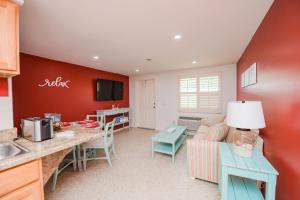 Il dispose d'une cuisine et d'un salon avec un canapé et une table. dans l'établissement Captain’s Quarters at Anna Maria Island Inn, à Bradenton Beach