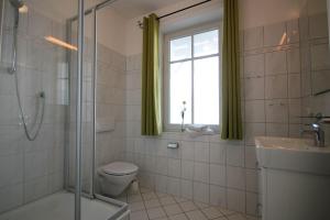 a bathroom with a toilet and a sink and a window at Villa Seydlitz - by Rujana in Binz +72 photos