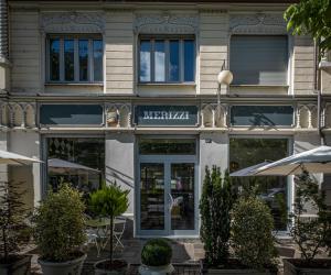 a building with a sign on the front of it at Eco Rooms&Breakfast Tirano in Tirano