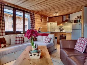 a living room with a couch and a table at Clos Donne Apartment - Snow and Trek- Essert Romand in Essert-Romand