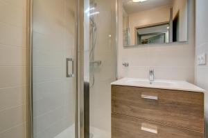 a bathroom with a sink and a shower at Bailicîmes Apartment - Snow and Trek - Morzine in Morzine +18 photos