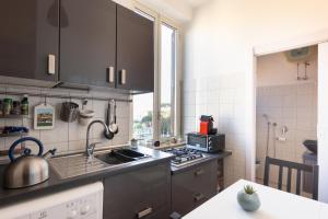 a kitchen with a sink and a stove top oven at Pigneto Life Nest in Rome