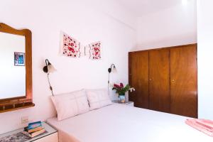 a bedroom with a bed with a mirror and a dresser at Olondio Apartments in Elounda
