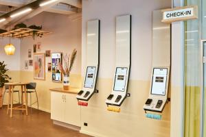 a store with three cell phones on a wall at CityHub Copenhagen in Copenhagen