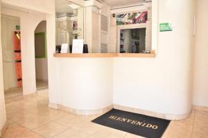 a counter in a store with a welcome sign on the floor at Casa Boston Inn in Barranquilla