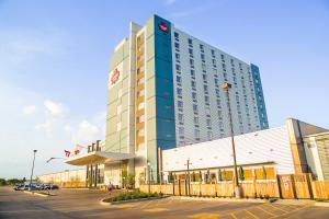 a tall building with a parking lot in front of it at Canad Inns Destination Centre Brandon in Brandon