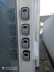 a row of parking meters on the side of a building at The Ferry Boat in Portmagee +67 photos