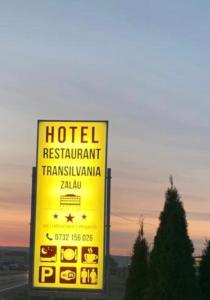a yellow sign for a hotel restaurant transmissionyrintharma at Hotel Transilvania Zalău in Zalău