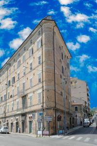 a large brick building on the corner of a street at La Marina in Ancona