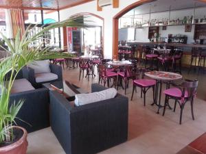 a restaurant with tables and chairs and a bar at Apartamentos Tabaiba in Costa Teguise